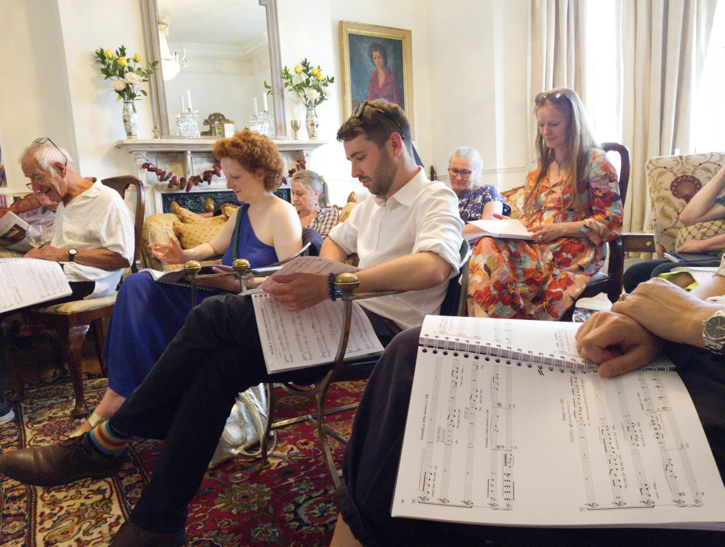 Writers, trustees and creative team gathered in a sitting room following the score during a June sing-through.